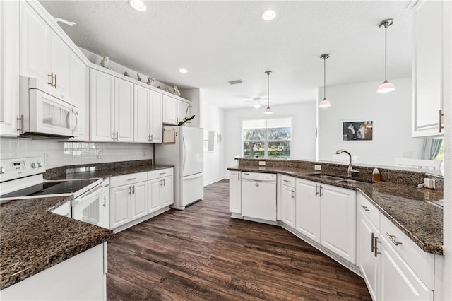 kitchen featuring white appliances, sink, dark wood-type flooring, ceiling fan, and decorative backsplash