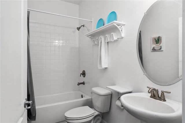 full bathroom featuring toilet, shower / bath combo with shower curtain, and sink