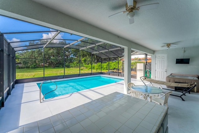 view of pool with a lanai, ceiling fan, and a patio area