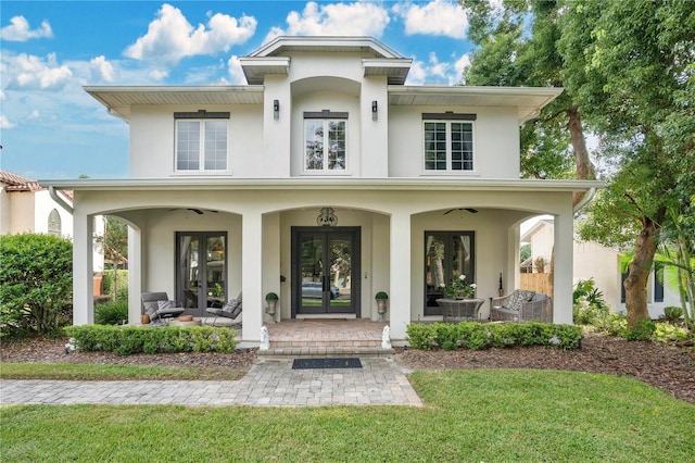 view of front of house featuring an outdoor hangout area, a front lawn, a patio area, and french doors