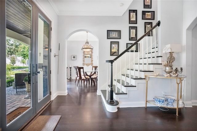 foyer entrance featuring dark hardwood / wood-style floors and ornamental molding