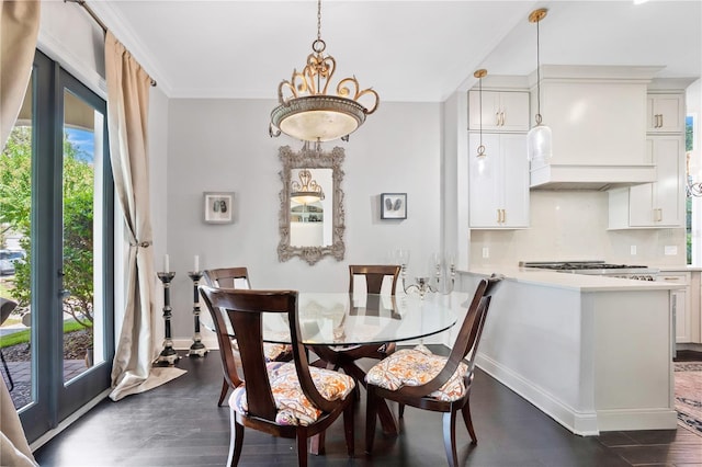 dining area featuring ornamental molding and dark wood-type flooring