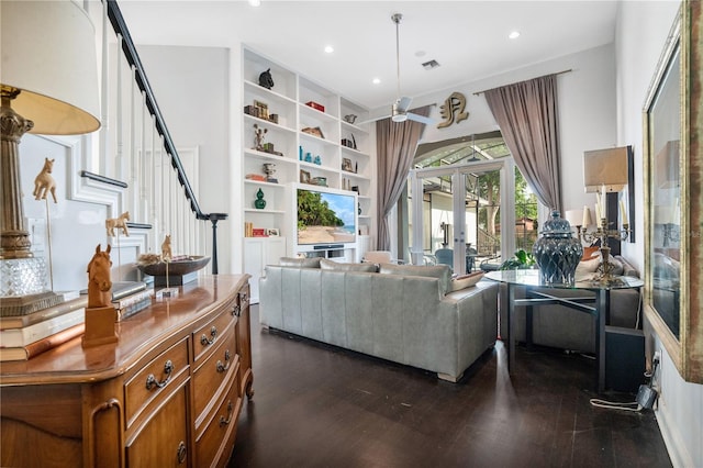 living room featuring french doors, plenty of natural light, and dark wood-type flooring