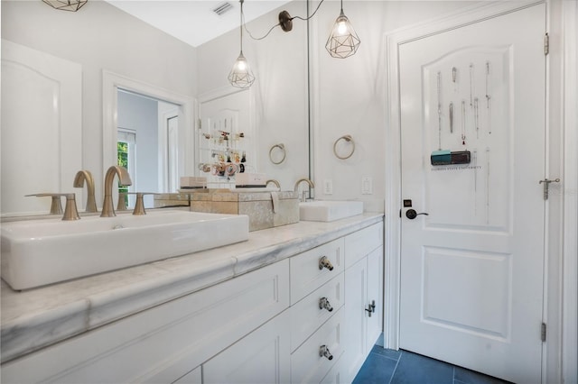 bathroom with tile patterned floors and vanity