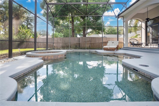 view of pool featuring ceiling fan, glass enclosure, an in ground hot tub, and a patio area