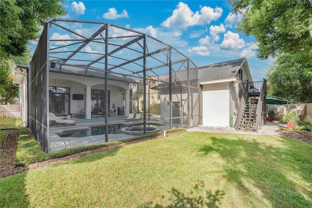 rear view of property featuring a lawn, a patio, a fenced in pool, and glass enclosure