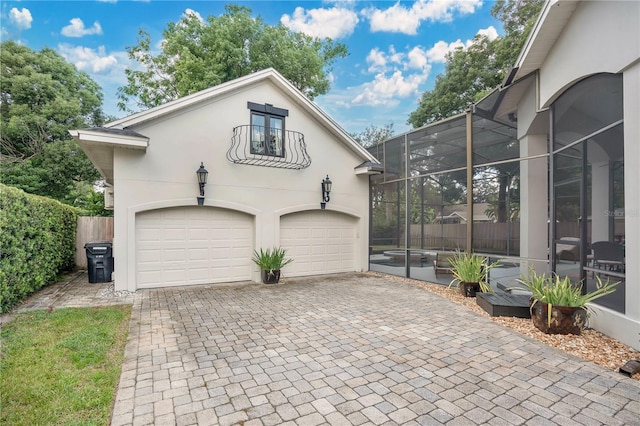 view of front of property with glass enclosure and a garage