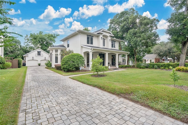 view of front of home with a front yard and a garage