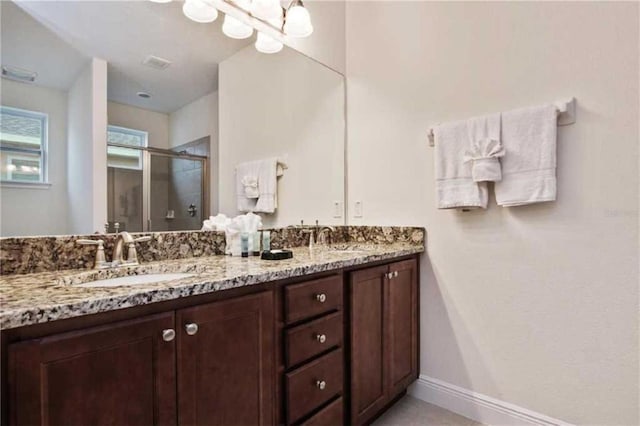 bathroom featuring vanity and a shower with door