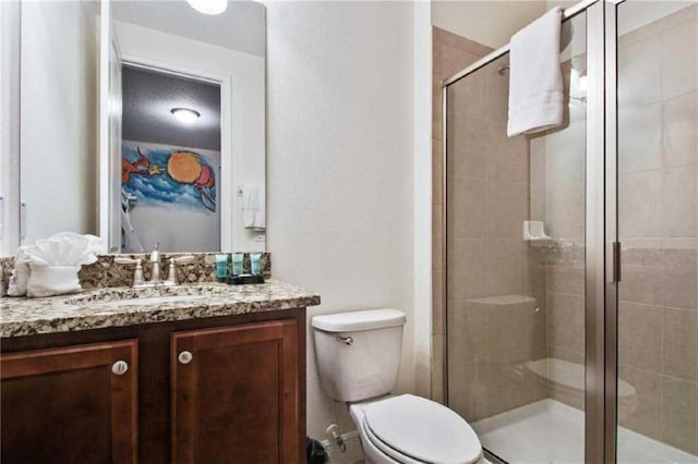 bathroom featuring vanity, toilet, and walk in shower