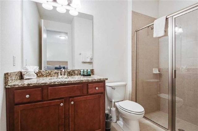 bathroom featuring vanity, toilet, and walk in shower