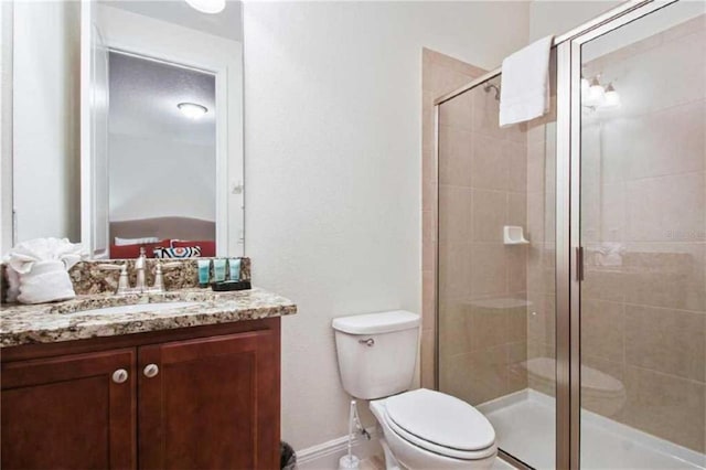 bathroom with vanity, toilet, and an enclosed shower