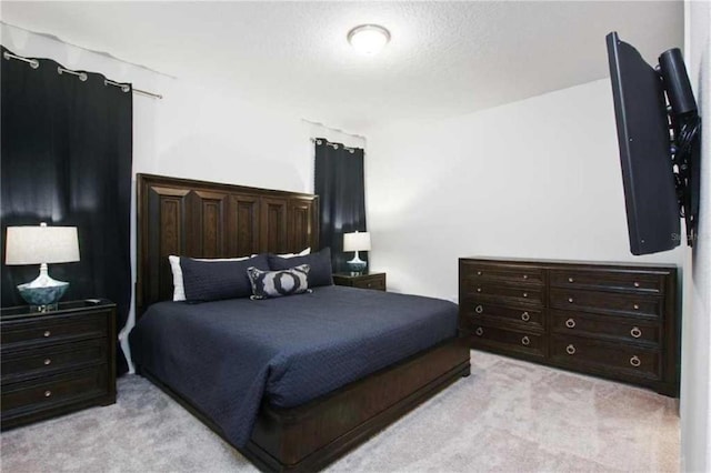 carpeted bedroom with a textured ceiling