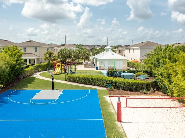 view of basketball court with a lawn and a playground