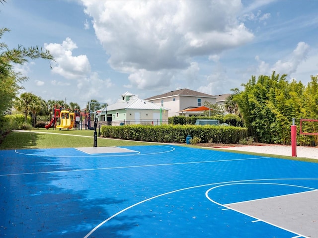 view of basketball court featuring a playground