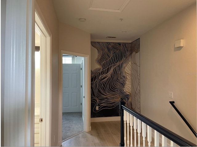 corridor with light hardwood / wood-style floors