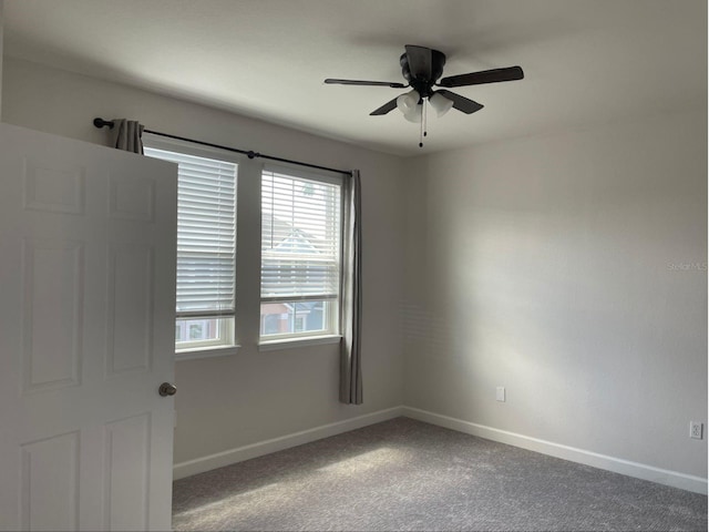 empty room featuring ceiling fan and carpet flooring