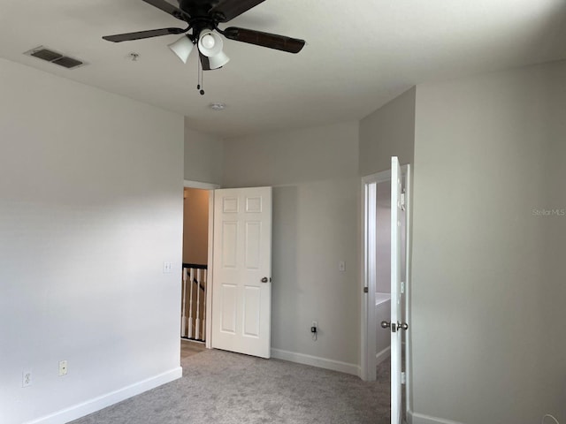 unfurnished bedroom featuring ceiling fan and light carpet