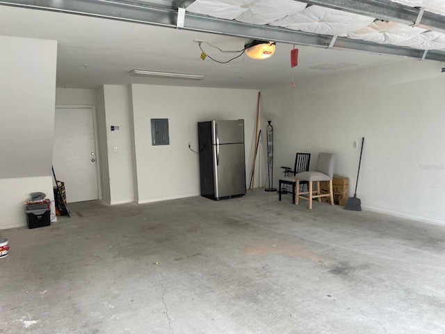 garage featuring stainless steel fridge, electric panel, and a garage door opener