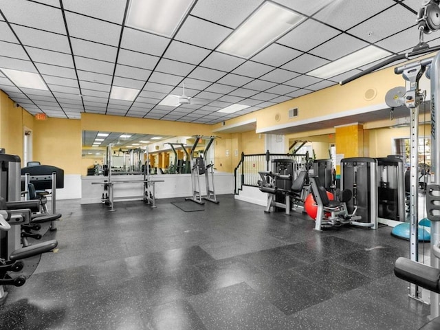 workout area with a paneled ceiling