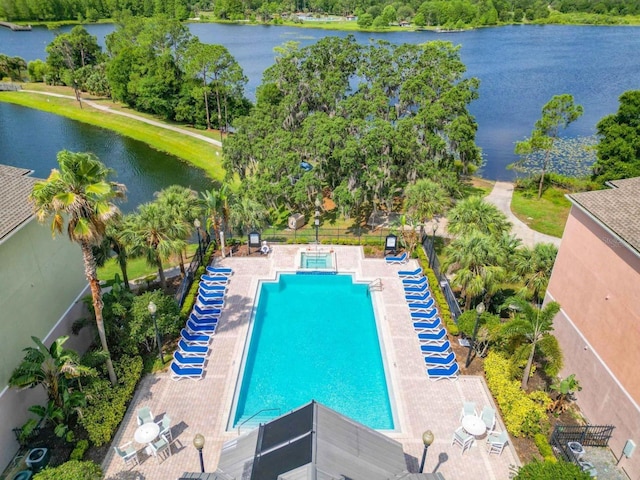 view of pool with a patio and a water view