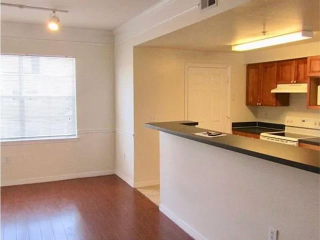 kitchen featuring white electric range oven and light hardwood / wood-style floors