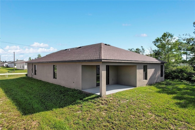 208 Hyacinth Ct, Kissimmee, FL 34759 - back of house featuring a patio, stucco siding, a lawn, and roof with shingles