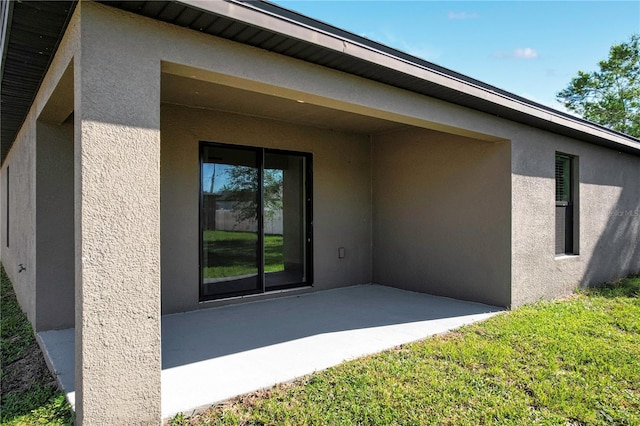 back of property with a patio area and a yard