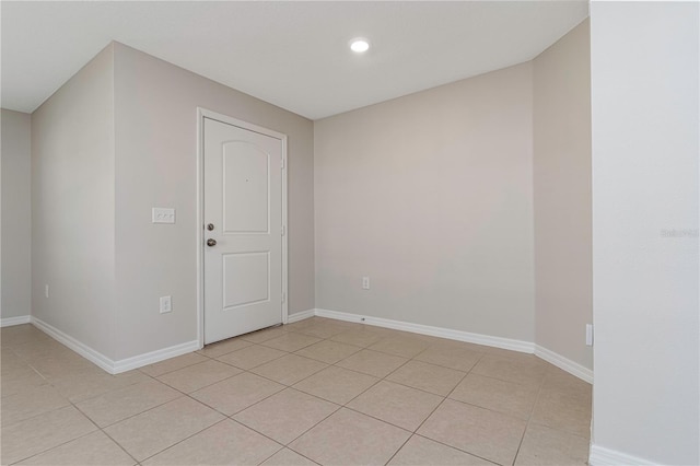 spare room featuring light tile patterned flooring