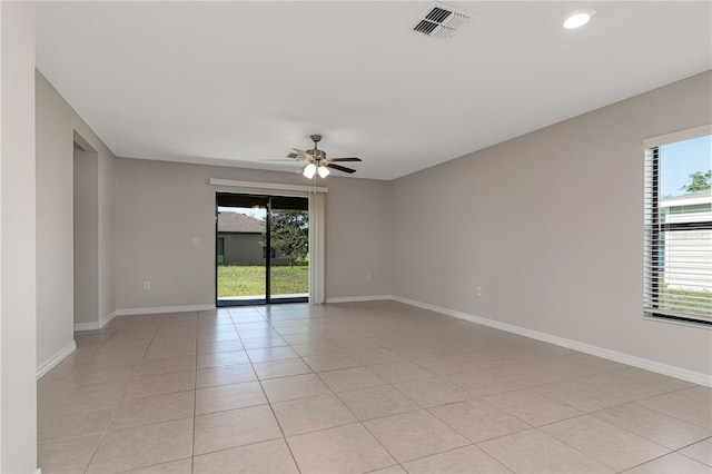 empty room featuring ceiling fan and light tile patterned flooring