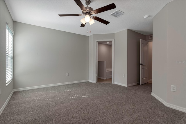 unfurnished bedroom with a textured ceiling, carpet, and ceiling fan