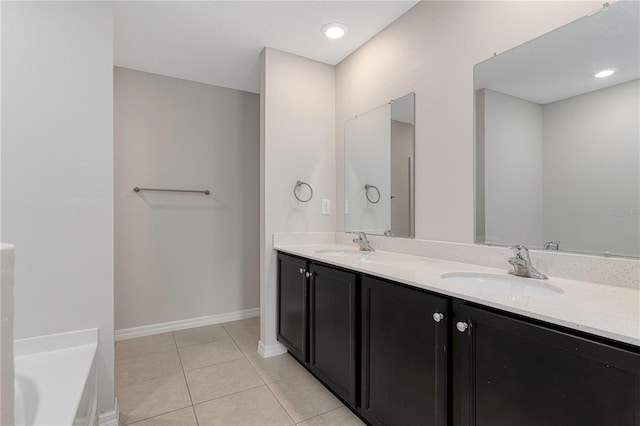 208 Hyacinth Ct, Kissimmee, FL 34759 - full bath featuring tile patterned flooring, double vanity, baseboards, and a tub