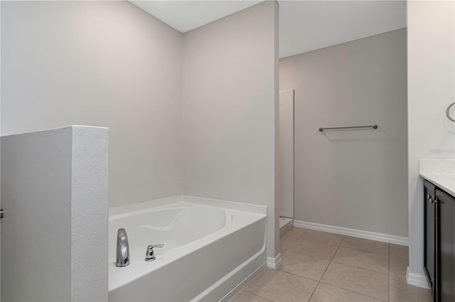 bathroom featuring vanity, tile patterned floors, and a bath