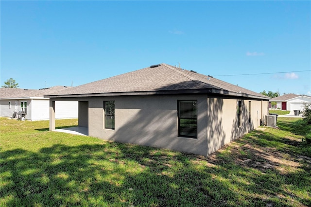 back of property featuring a patio area, central AC, and a yard