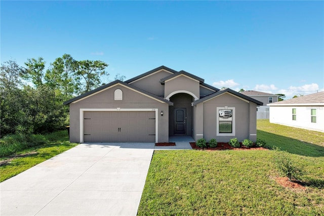 ranch-style house featuring a front yard and a garage