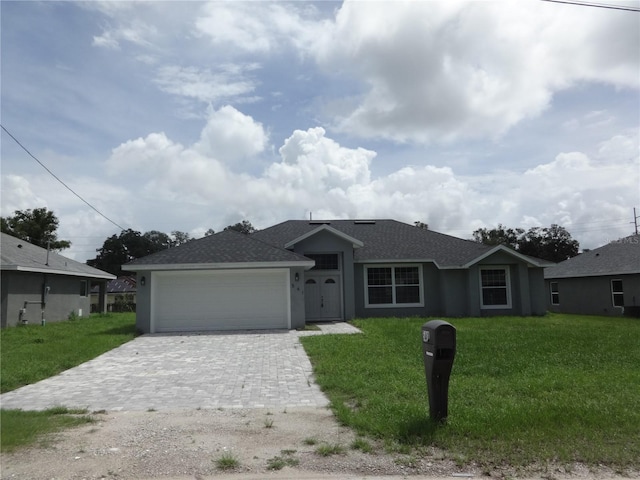 single story home with a garage and a front yard