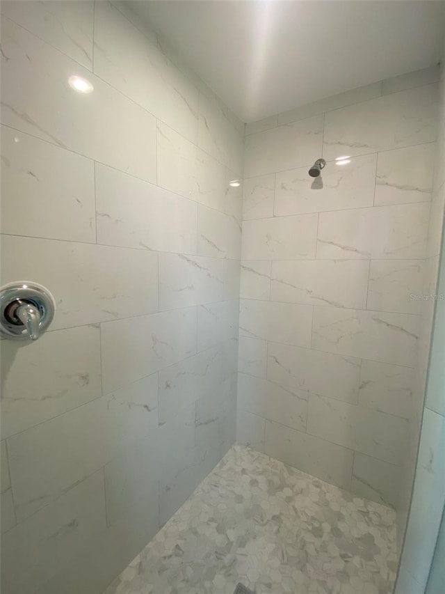 bathroom with tiled shower