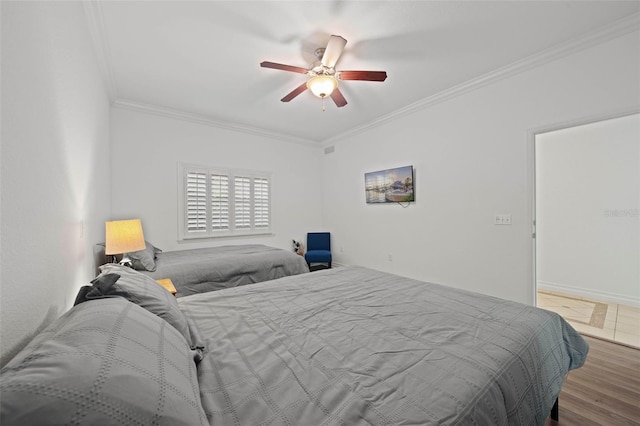 bedroom featuring hardwood / wood-style floors, ceiling fan, and ornamental molding