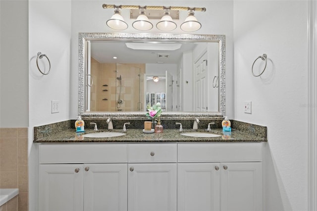 bathroom featuring tile walls, independent shower and bath, and vanity