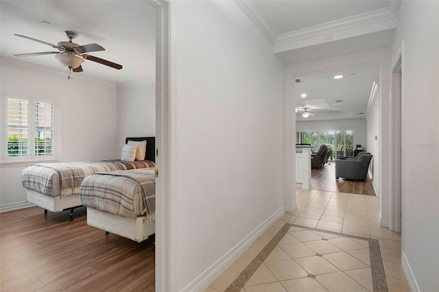 bedroom with light wood-type flooring, crown molding, and ceiling fan