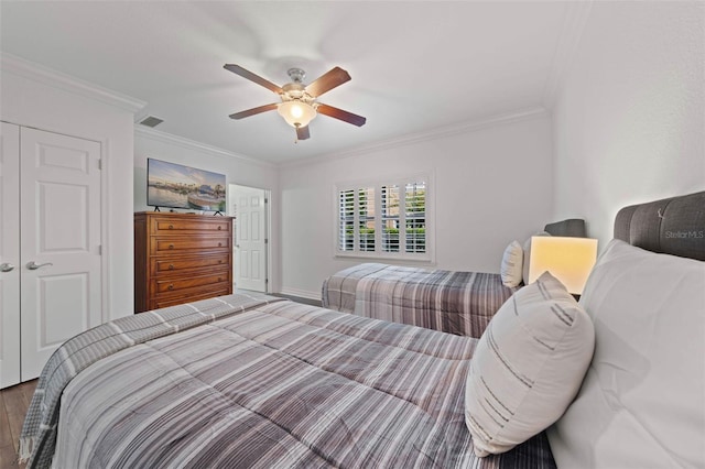 bedroom featuring crown molding, hardwood / wood-style floors, ceiling fan, and a closet