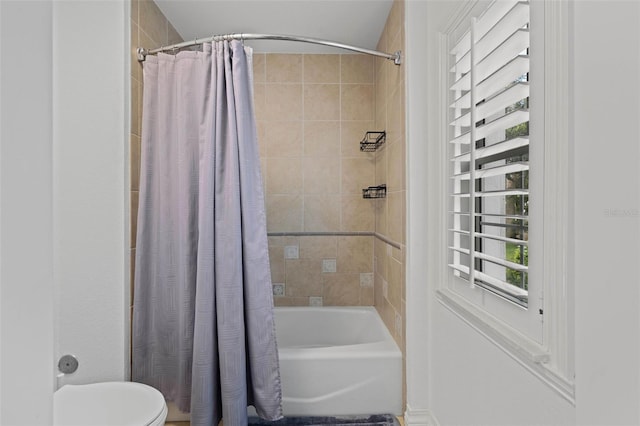 bathroom featuring shower / bath combo and toilet