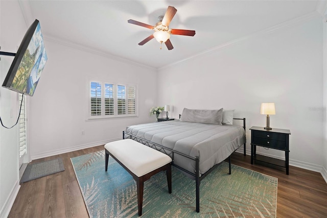 bedroom featuring dark wood-type flooring, ceiling fan, and ornamental molding