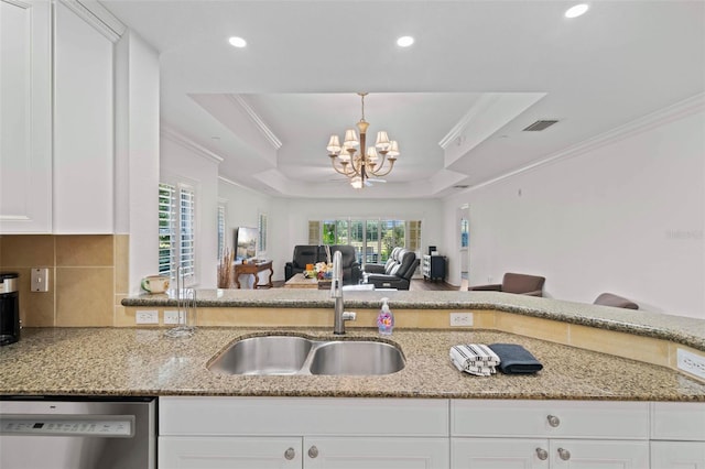 kitchen featuring dishwasher, a raised ceiling, light stone countertops, and sink