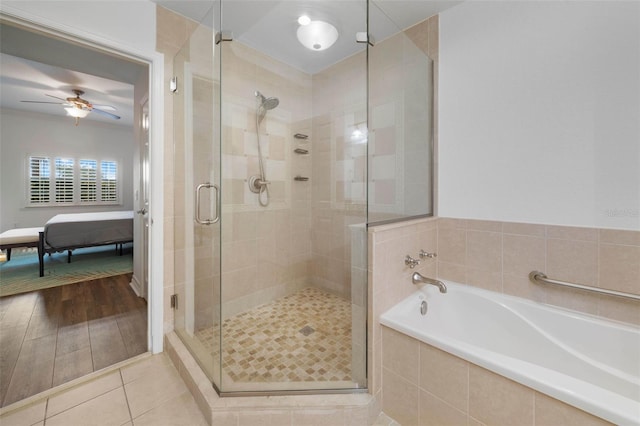 bathroom with ceiling fan, hardwood / wood-style flooring, and shower with separate bathtub