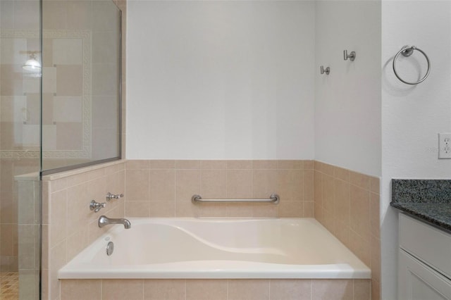 bathroom featuring shower with separate bathtub and vanity