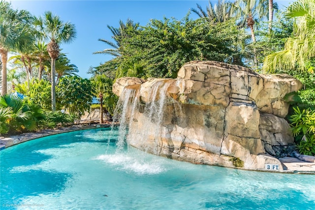 view of swimming pool featuring pool water feature