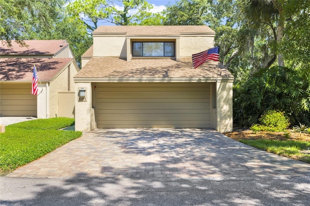 view of front of house with decorative driveway and stucco siding