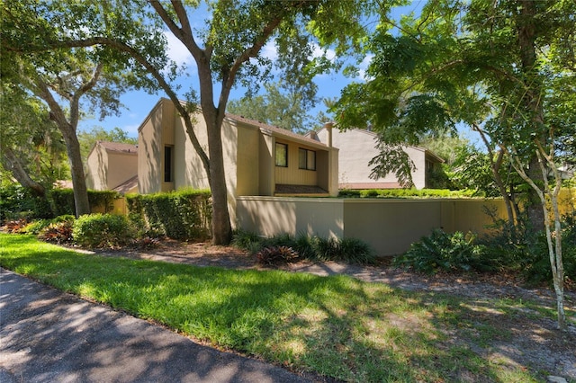 view of property exterior with fence and stucco siding