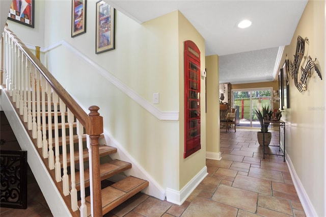 stairs with a textured ceiling